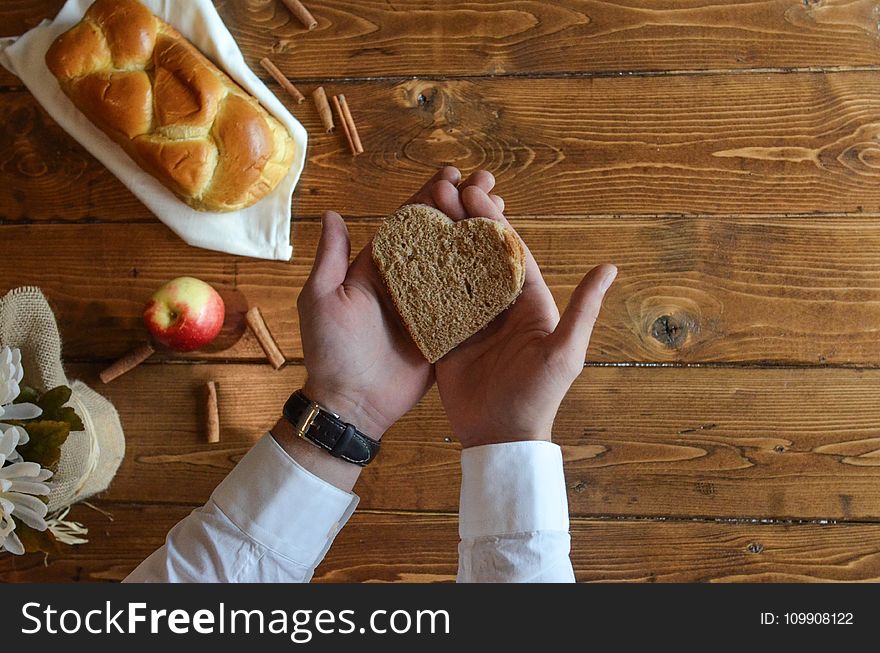 Person Holding Heart Shaped Bread