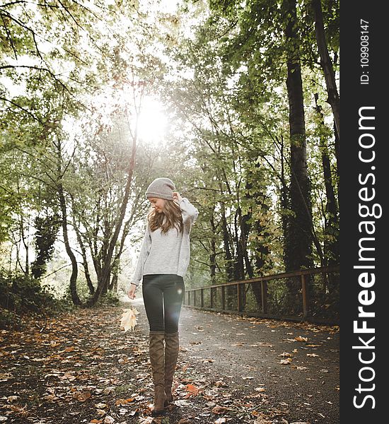 Woman in Gray Sweater Standing Between Forest Trees