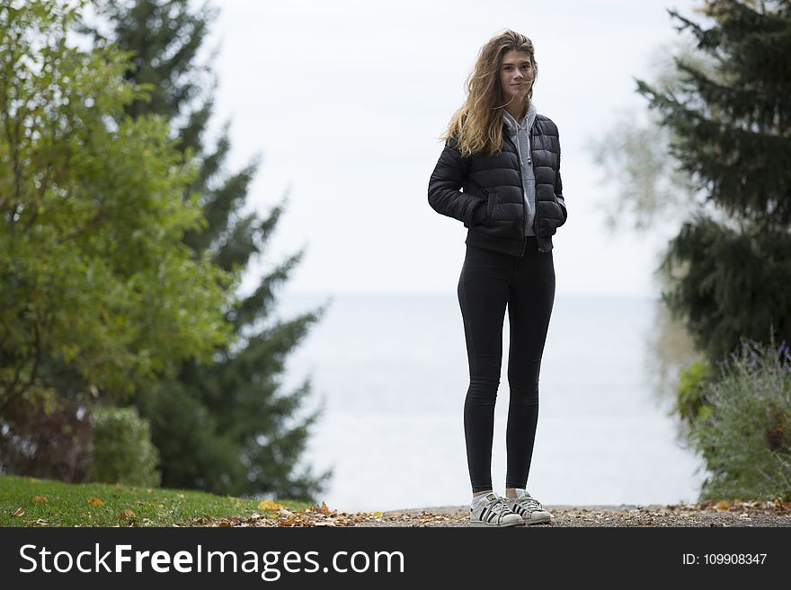 Woman in Black Winter Jacket Near Trees