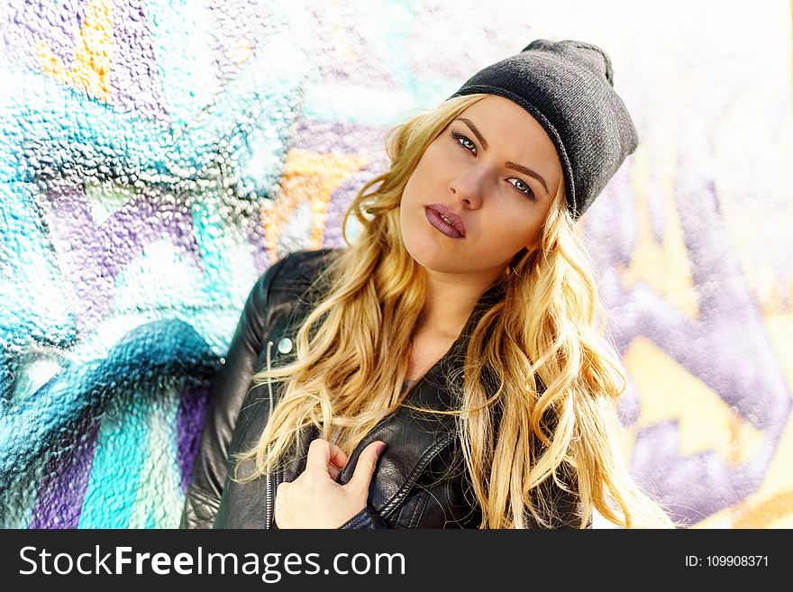 Woman Wearing Black Leather Jacket and Black Knit Cap