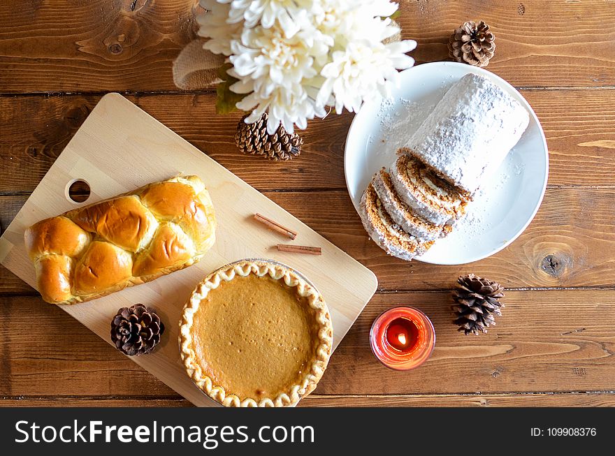 Brown Pastry And Cupcake In Chopping Board