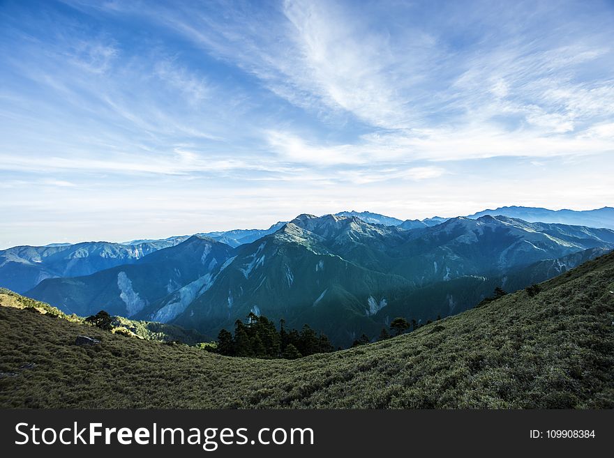 Landscape Photograph Of Mountains Under Blue Cloudy Sky