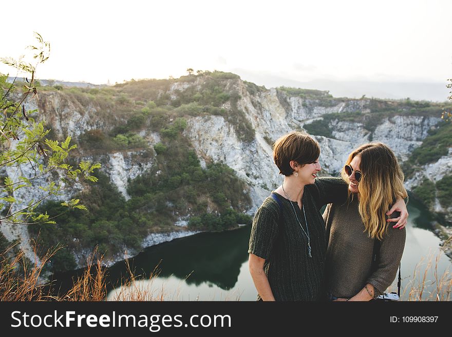 Two Woman Standing on a Cliff