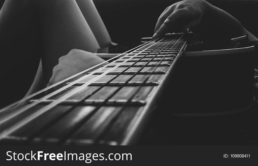 Person Holding An Acoustic Guitar