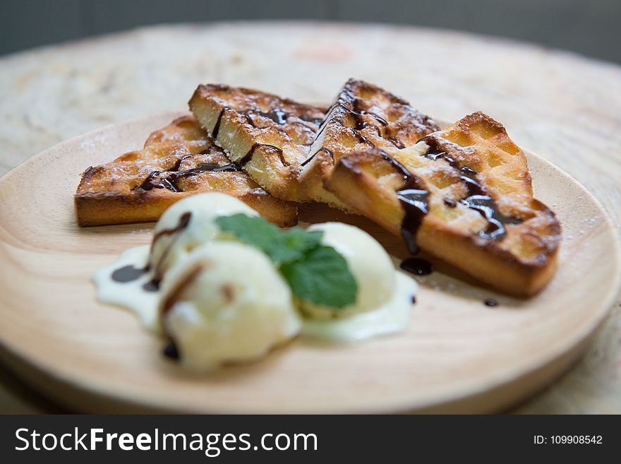 Shallow Focus Photography of Baked Bread With Chocolate Syrup Serve on Wooden Plate
