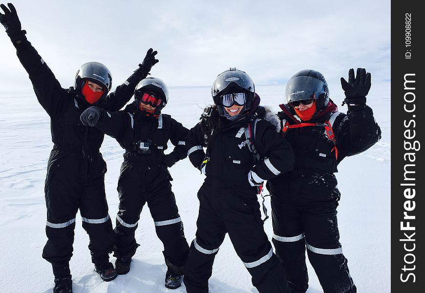 Four Person Wearing Black Snow Suit