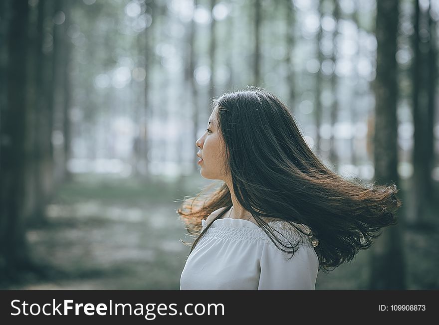 Woman In White Off-shoulder Dress Near Trees