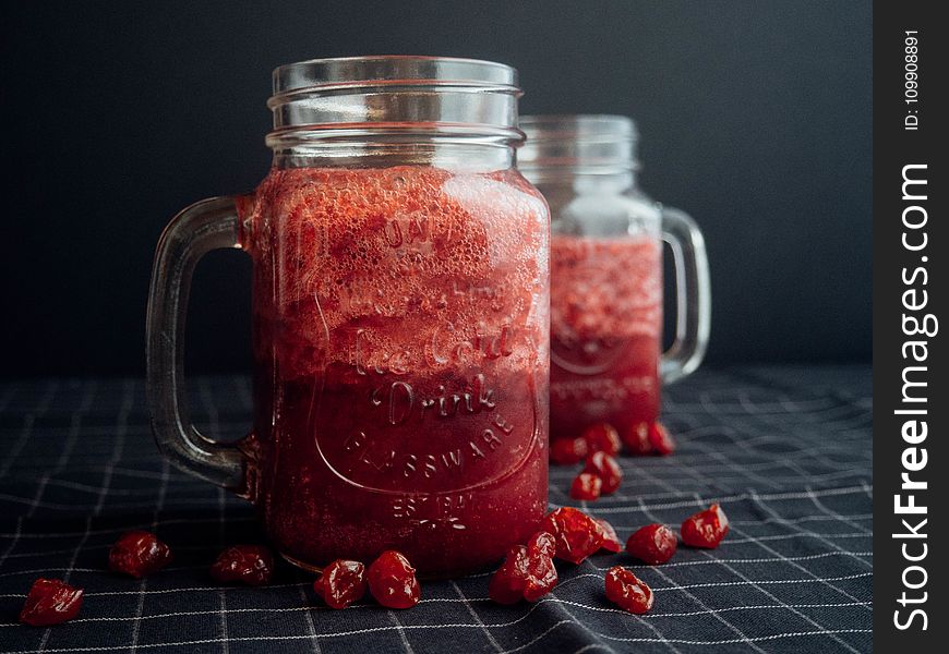 Mason Jar Filled With Cranberry Juice On Black and White Checked Cloth