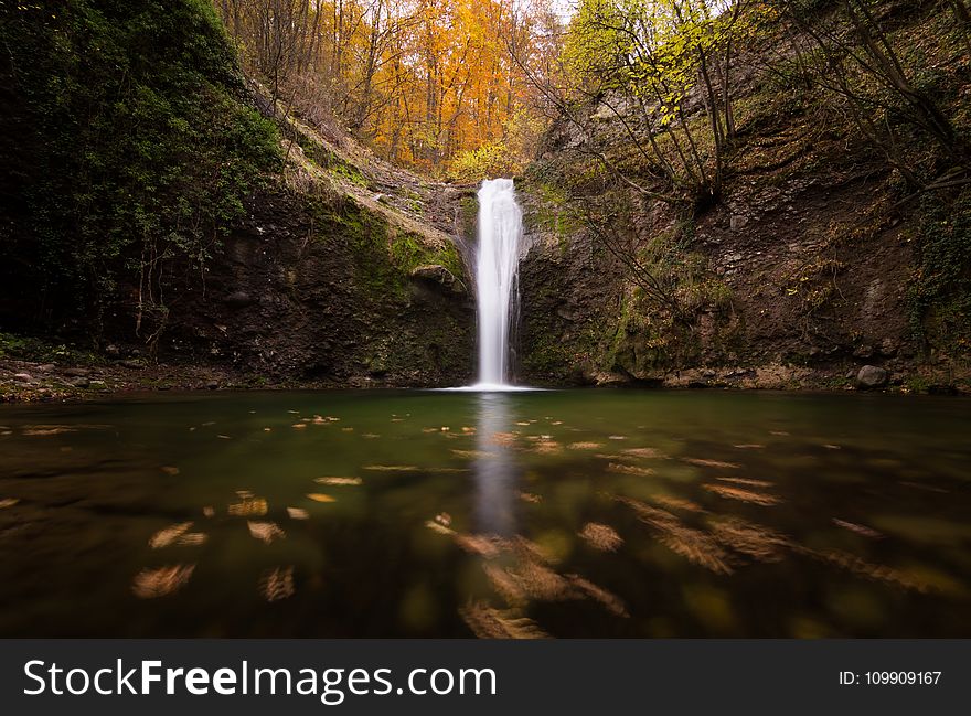 Low Angle Photo of Waterfalls Surrounded by Trees