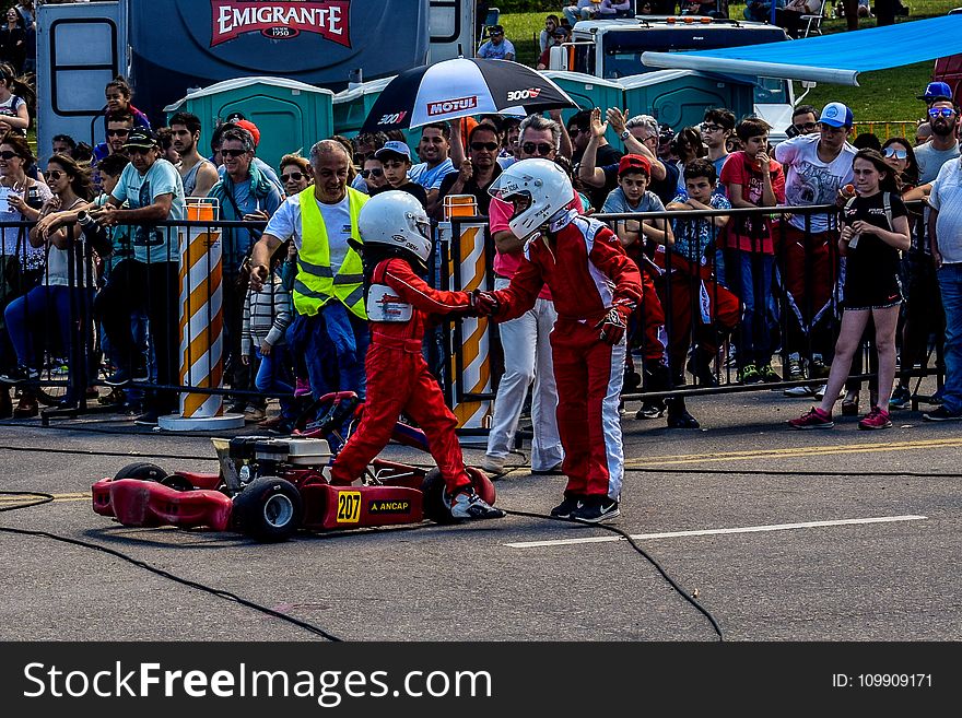 Two Boy in Red and White Racing Costume