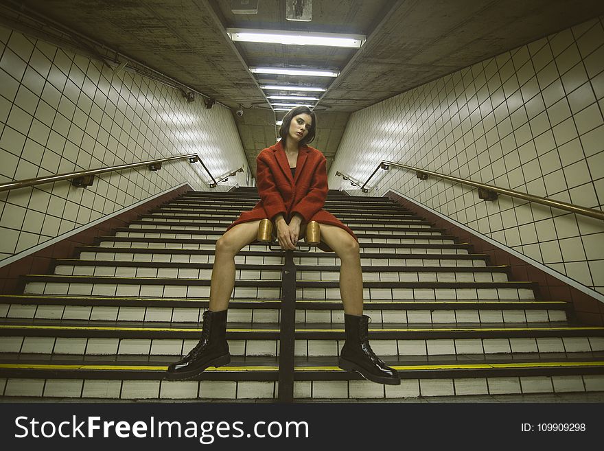 Woman Sitting on Handrail With Both Hand on Front
