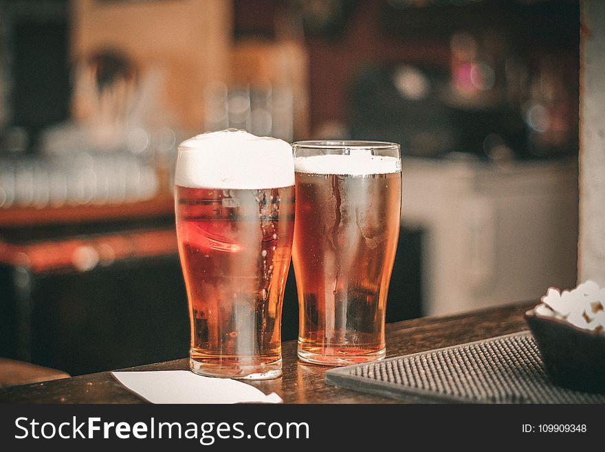 Depth of Field Photo of Two Pilsner Glasses