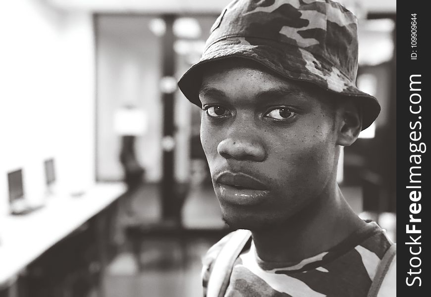 Man Wearing Camouflage Crew-neck T-shirt and Hat