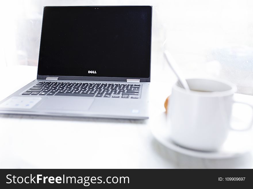 Dell Laptop in Front of Cup of Coffee