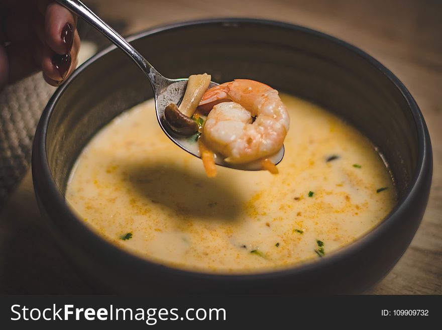 Bowl of Shrimp Soup on Brown Wooden Surface