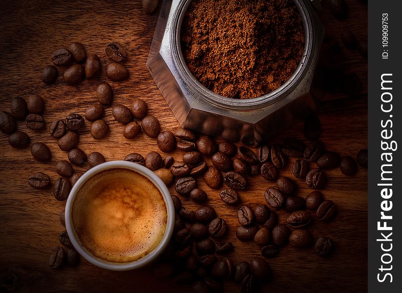 White Ceramic Mug Filled With Coffee Beside Coffee Beans