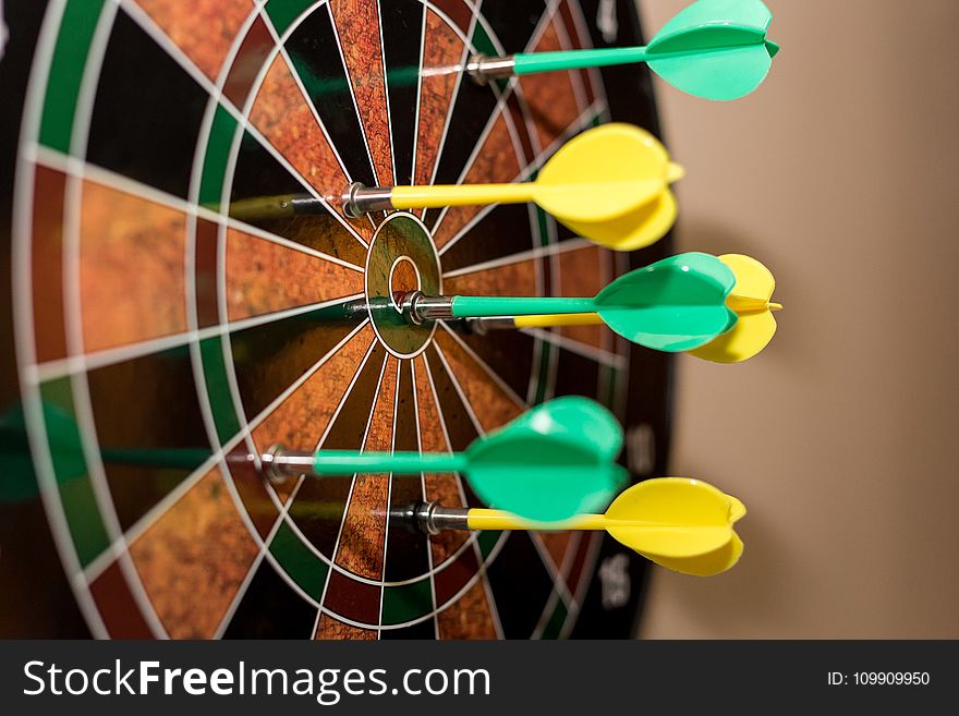 Green And Yellow Darts On Brown-black-green-and-red Dartboard