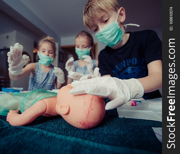 Three Children Playing Operation Toy