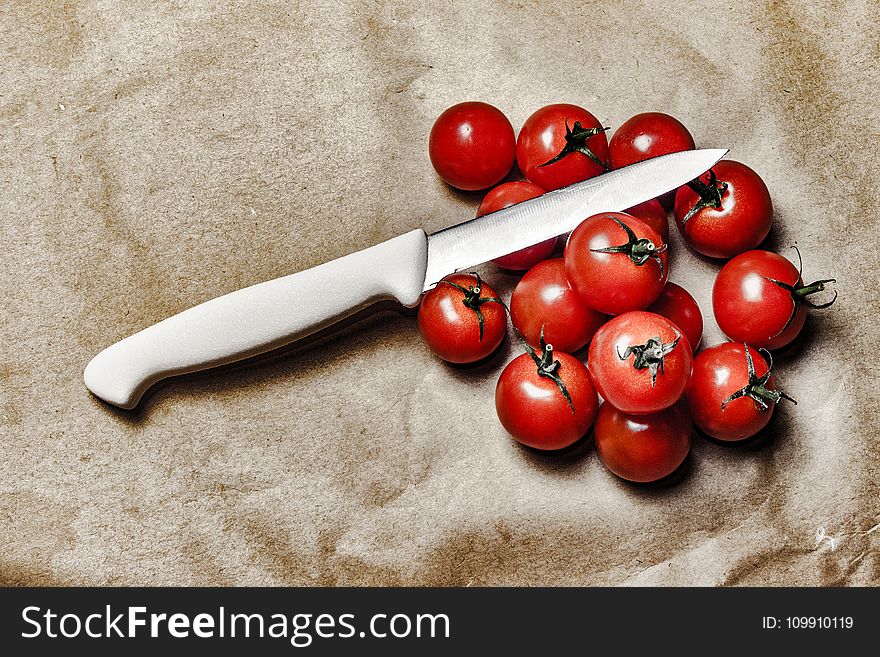 Tomatoes With Knife on Brown Surface