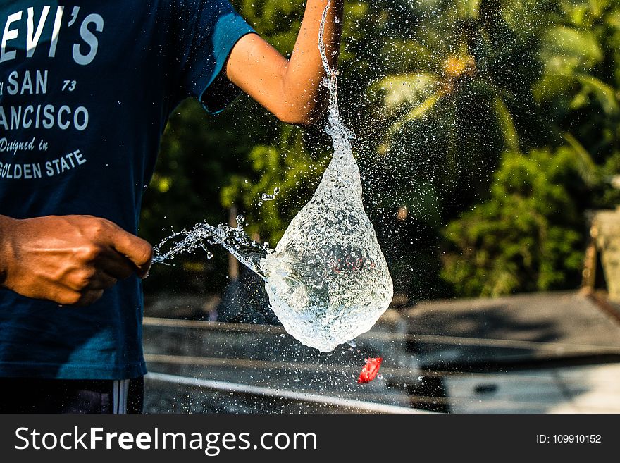 Person in Black Shirt Pouring Water