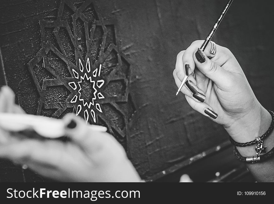 Black and White Photo of Hands Holding a Paintbrush