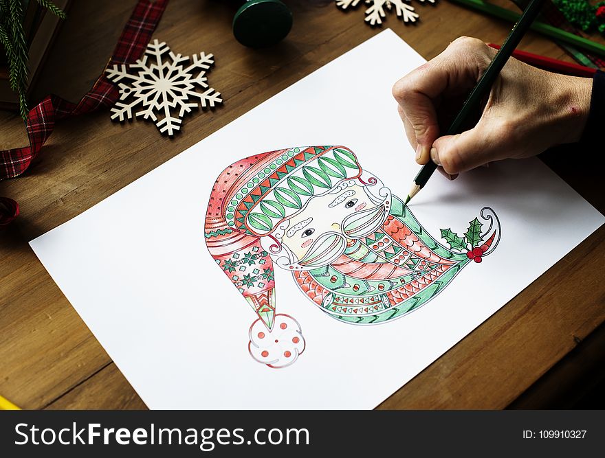 Person Drawing Gnome on White Printer Paper