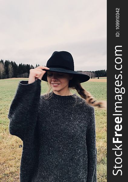 Woman Wearing And Holding Black Summer Hat Outdoor