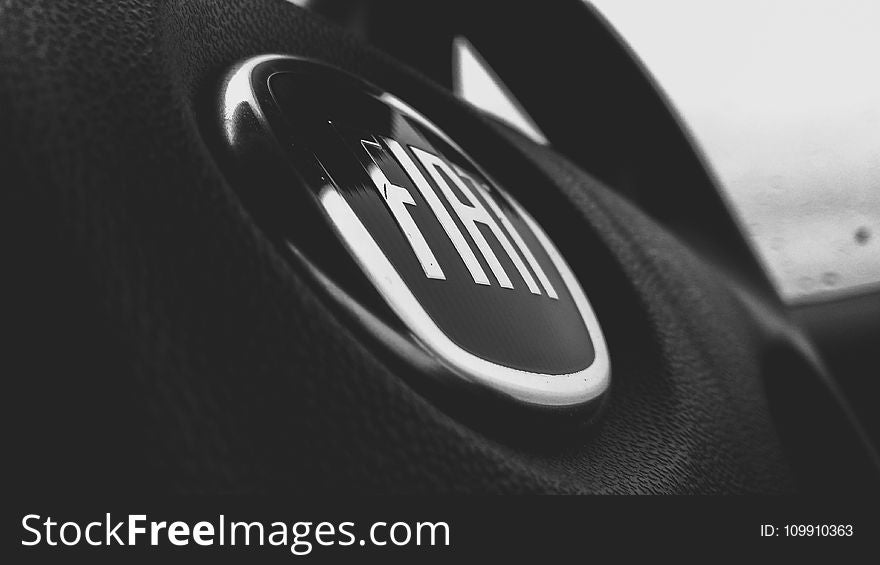 Greyscale and Closeup Photograph of Fiat Steering Wheel