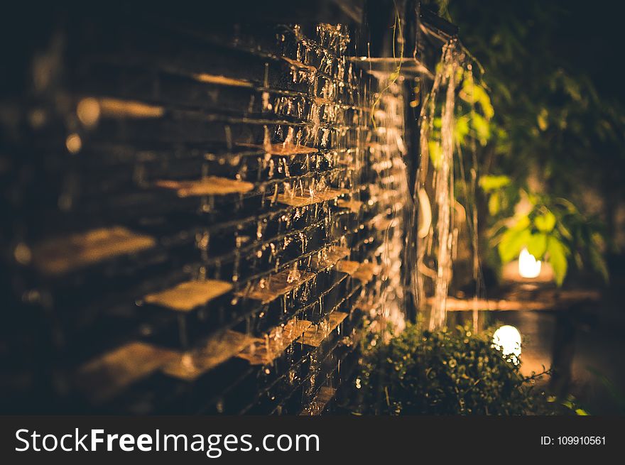 Selective Focus Photography Of Brown Brick Wall During Nighttime