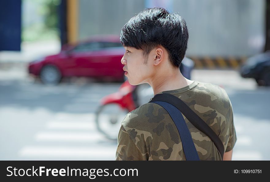 Man in Green and Gray Camouflage Shirt