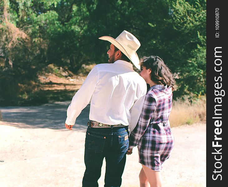 Man Wearing White Dress Shirt And White Cowboy Hat