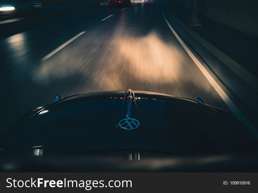 Black Volkswagen Car on Gray Asphalt Road