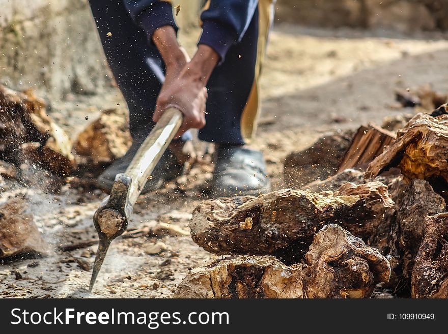 Person Smashing Pick Axe On Ground