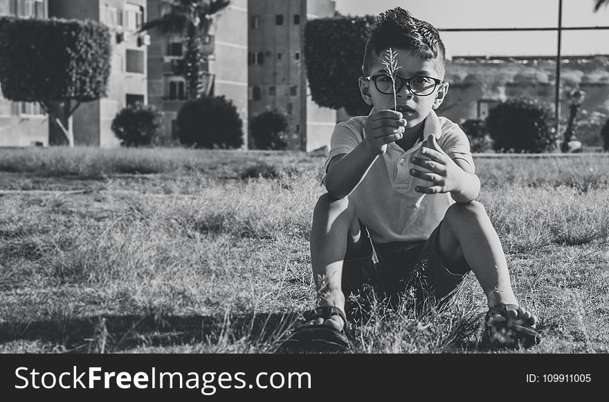 Greyscale Photo Of Boy Wearing Eyeglasses