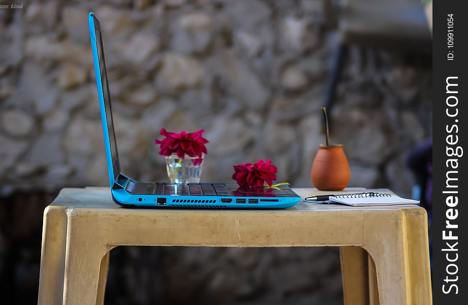 Blue Laptop Computer On Brown Plastic Table