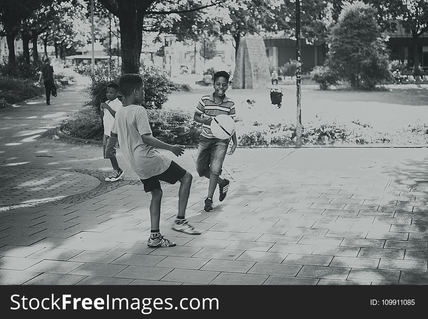 Grayscale Photography Of Kids Playing Ball