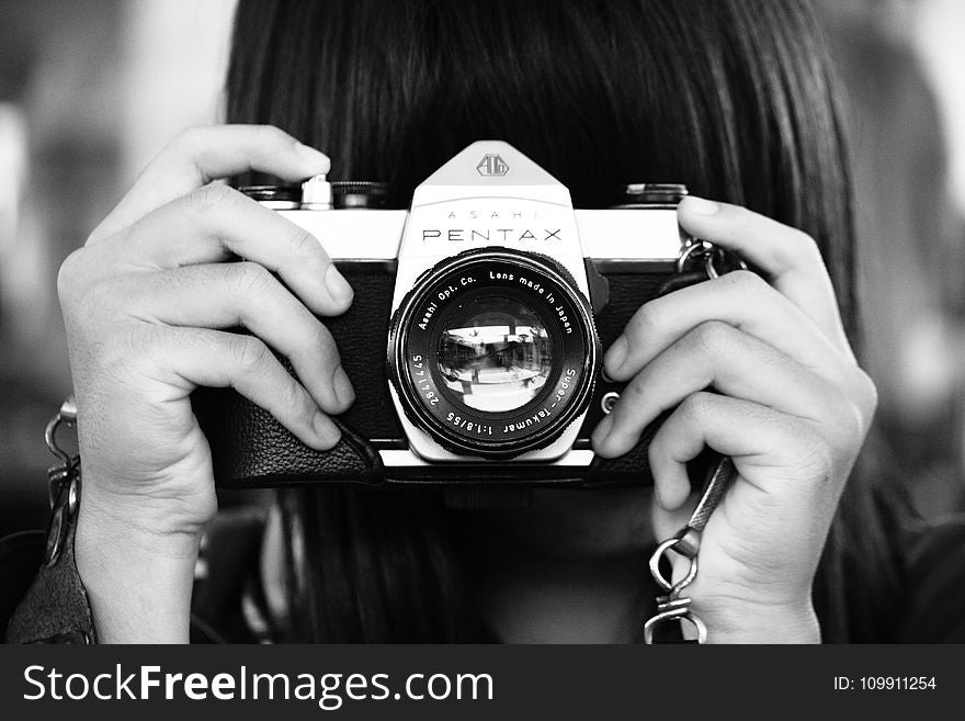 Woman Holding Dslr Camera in Grayscale Photography
