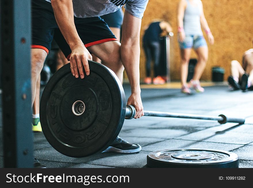 Man Holding Black Barbell