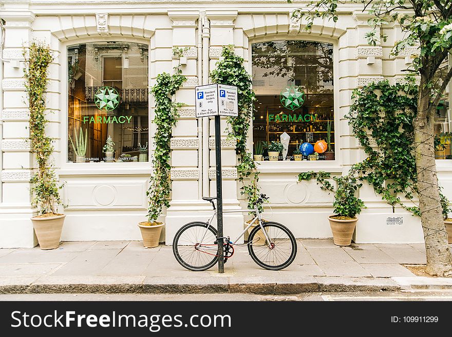 Black And White Bicycle Beside Post