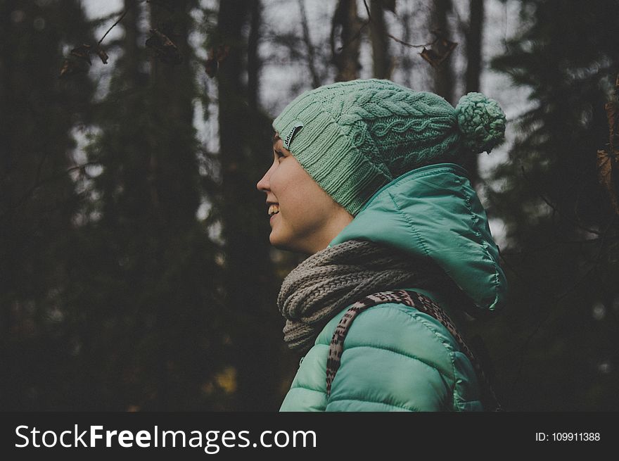 Low Light Photo of Person Wearing Green Jacket and Hat