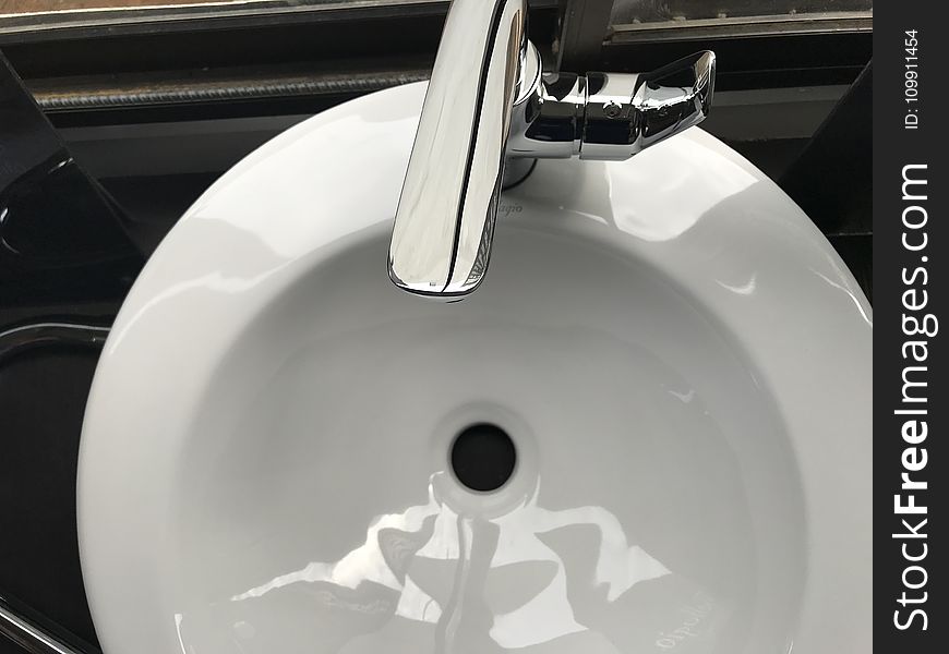 White Ceramic Sink With Stainless Steel Faucet