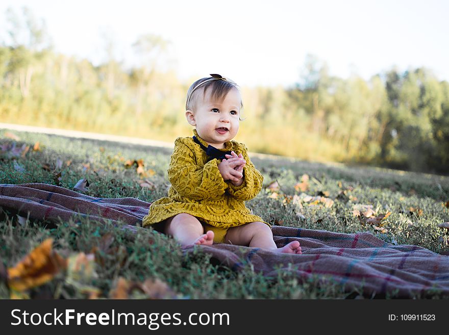 Baby Wearing Yellow Crochet Long Sleeve Dress Sitting on Brown Textile