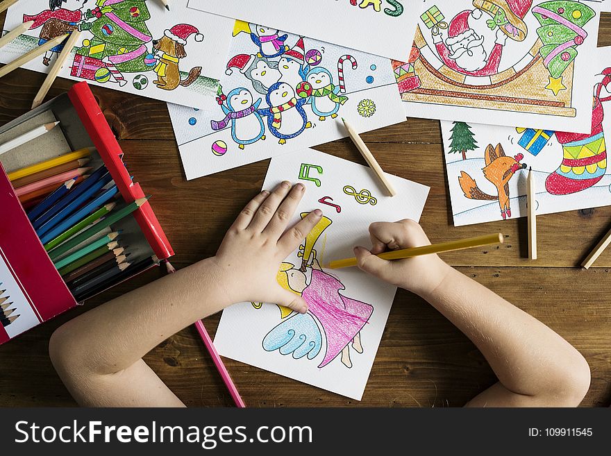 Top Angle Photo Of Child Holding Pencil While Drawing Female Angel Playing Wind Instrument