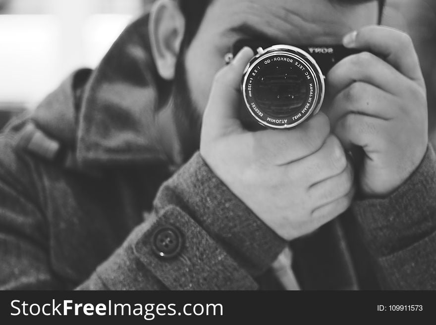 Man Taking Photo Using Black Dslr Camera
