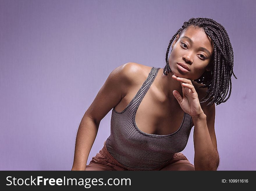 Woman In Black And White Tank Top Posing For Picture