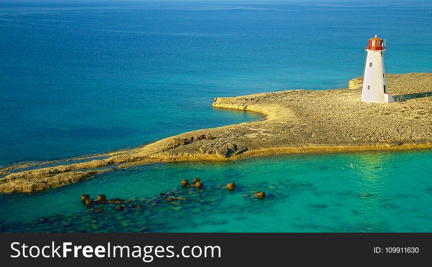 Bird&#x27;s Eye Photography of White Lighthouse on Island