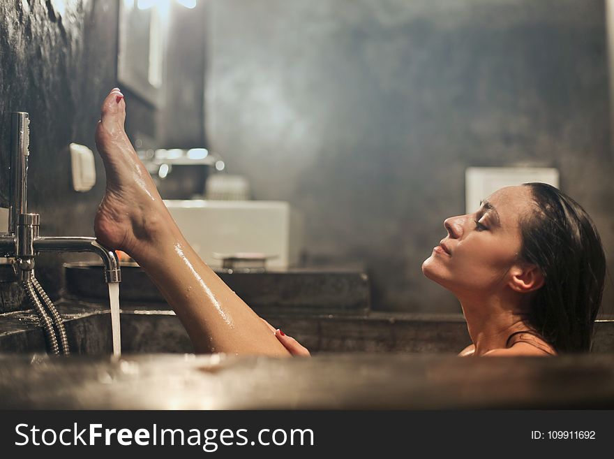 Woman on Gray Concrete Bath Tub