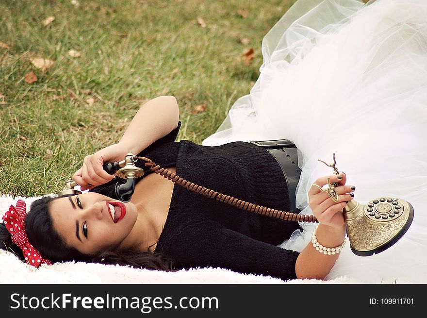 Woman In Black And White Tutu Dress Holding Cradle Phone