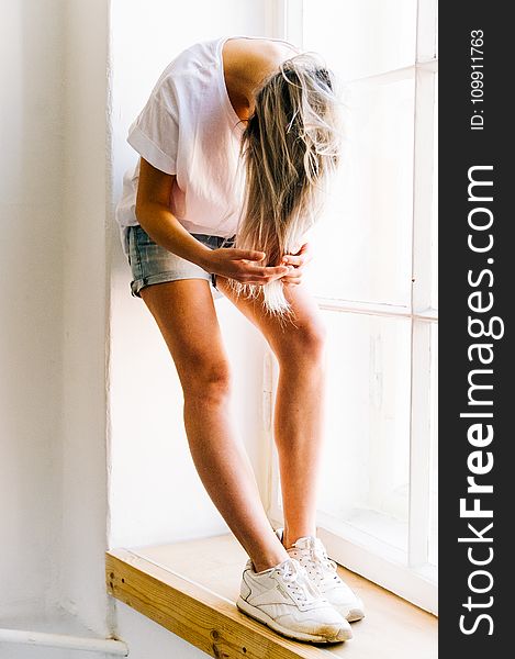 Woman in White T-shirt and Blue Denim Shot Shorts