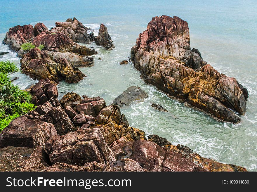 Brown Rock Formations Beside Ocean